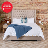 Beige tufted velvet bed with high upholstered headboard and matching base featuring 100% organic bamboo silk duvet cover