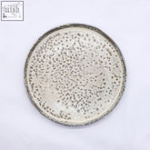 A 23 cm saltfoam stoneware handmade ceramic dinner plate with a speckled matte finish in muted gray and white tones