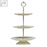 Antique white ceramic 3 tier cake plate with ornate silver handle and decorative lace edges, perfect for star sign mugs display