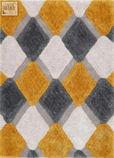A plush ochre geometric shaggy rug with raised diamond shapes in mustard yellow charcoal gray and off-white