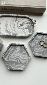 4 piece trinket set with gray and white marbled concrete trays in oval and hexagonal shapes for jewelry storage