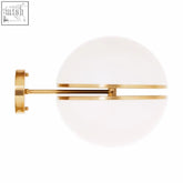 Abira brushed brass ball wall light features a gold-toned brass wall sconce with frosted white glass shade and minimalist bars