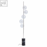 Modern abira nickel floor lamp with slender chrome pole and five glass spheres on a black marble base