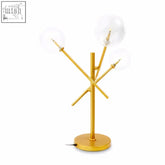 Gold-toned abira three bulb table lamp with modern branching design and four clear glass globe shades