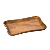 A smooth light brown acacia large curved rectangle serving dish with natural wood grain and a gently curved shape