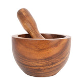 A polished acacia wood kora small mortar and pestle set with a smooth rounded bowl and matching handle
