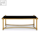 Ackley gold coffee table with black glass top and gold toned metal frame for stylish living room use