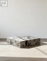 Aesop low coffee table a sleek square marble coffee table in white with gray veining and a unique split design revealing an inner compartment