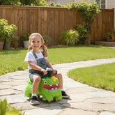 Green AIYAPLAY dinosaur ride on toy with interactive steering wheel and storage compartment for toddlers