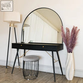 Black vanity table with akiko black arched metal mirror featuring gold-tone legs and drawer pulls for stylish use
