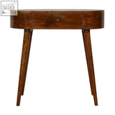 A sleek oval-shaped albion chestnut console table made of solid mango wood with a single drawer and tapered legs