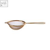 Gold finish stainless steel round sieve with fine mesh and slender handle for precise tea straining