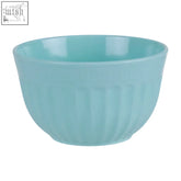 A smooth light blue ceramic mixing bowl with vertical ridges contrasting alden melamine medium green mixing bowls