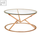 Modern rose gold coffee table with clear glass top and geometric metal base perfect for stylish living spaces