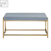 A sleek allure gold bench with a powder blue upholstered seat and polished gold metal frame perfect for modern spaces