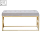 A sleek allure mink velvet bench with a light gray tufted mink velvet seat and gold finish x-shaped metal frame
