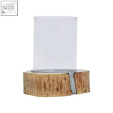 Clear glass hurricane candle holder with large acacia wooden base showing natural bark edges and wood grain
