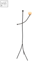 Black metal floor lamp aluminium balancing act with minimalist stick figure design and orange spherical bulb