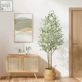 Tall faux olive tree with green leaves black olives and natural wood trunk in woven wicker pot for indoor outdoor use