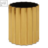 Gold-colored fluted cylindrical container with black interior on alvaro black and titanium round side table