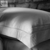 White linen pillow from amalfi bundle with subtle ladder stitch border for a stylish white bed set