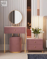 A blush pink amani dressing table set with gold legs and a round mirror perfect for stylish bedroom use