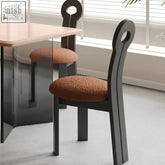 Black amaris dining chair with boucle textured brown cushion and looped back design perfect for dining room