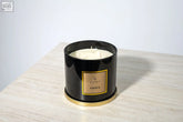 Black cylindrical amber 3 wick luxury candle with gold trim from li home perfect for large candle collection