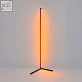 A sleek ambient rgb corner floor lamp with warm orange vertical led strip on a dark metal tripod base