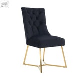 Black tufted velvet dining chair with gold-plated stainless steel legs and ring pull for luxury accent seating
