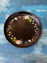 Dark brown ceramic plate tray with delicate pink white yellow floral border on black lacquer chinoisserie design
