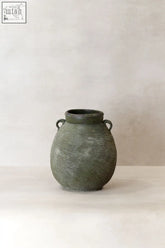 A matte olive green ceramic preserve pot with loop handles and textured ridges from the river region collection