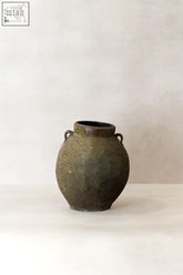 A rustic olive green ceramic antique preserve pot with two looped handles and a textured surface perfect for preserving