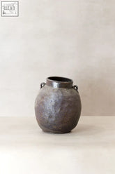 A matte dark gray ceramic antique preserve pot with two looped handles perfect for storing preserves