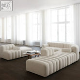 Cream-colored aoko sofa with plush textured fabric and distinctive ribbed tufted design for cozy seating