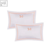 White arabella bow oxford pillowcase pair with delicate peach embroidered bows and matching piping for a soft look