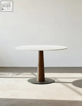 Archibald round dining table with a white marble top and bronze pedestal base perfect for round dining spaces