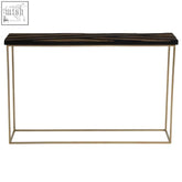 A sleek aris black and gold console table with a dark wood grain top and slender gold console metal legs