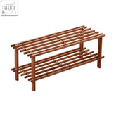 Brown wooden two-tier shoe rack in dark cedar wood with slatted shelves and sturdy legs for tidy storage