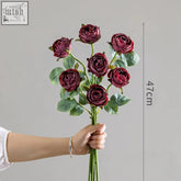 A bouquet of six deep burgundy artificial roses with green leaves for european entry lux rose living room decor