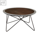 Artisan acacia coffee table with dark wood top edged in black and white chevron pattern on slim iron legs