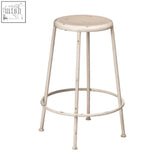 A distressed artisan cream metal bar stool with a round seat and circular footrest for comfy seating