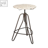 Artisan cream metal bar table with a round white speckled terrazzo stool and sleek black hairpin metal legs