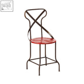 Artisan red metal seat chair with red enamel top and black wrought iron x-shaped backrest metal seat chair