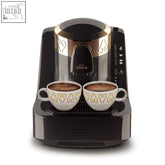 Black and gold arzum okka automatic turkish coffee machine with two white ceramic cups featuring gold patterns and auto altitude detection
