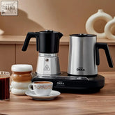 Black and silver arzum okka rich moka pot with stainless steel body and black accents for turkish coffee and milk frothing