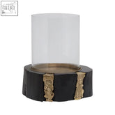 Black wood slice hurricane candle holder with gold leaf accents and clear glass cylinder for cozy lighting