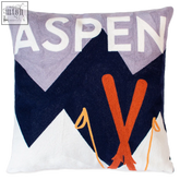 Cozy aspen needlepoint cushion with embroidered mountain design and bold white aspen text above orange skis and yellow poles