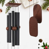 Black metal wind chimes outdoor with wooden accents and dark wood top producing a deep tone for garden decor