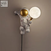 White astronaut wall light with gold helmet and glowing moon globe perfect for kids bedroom uk plug in use